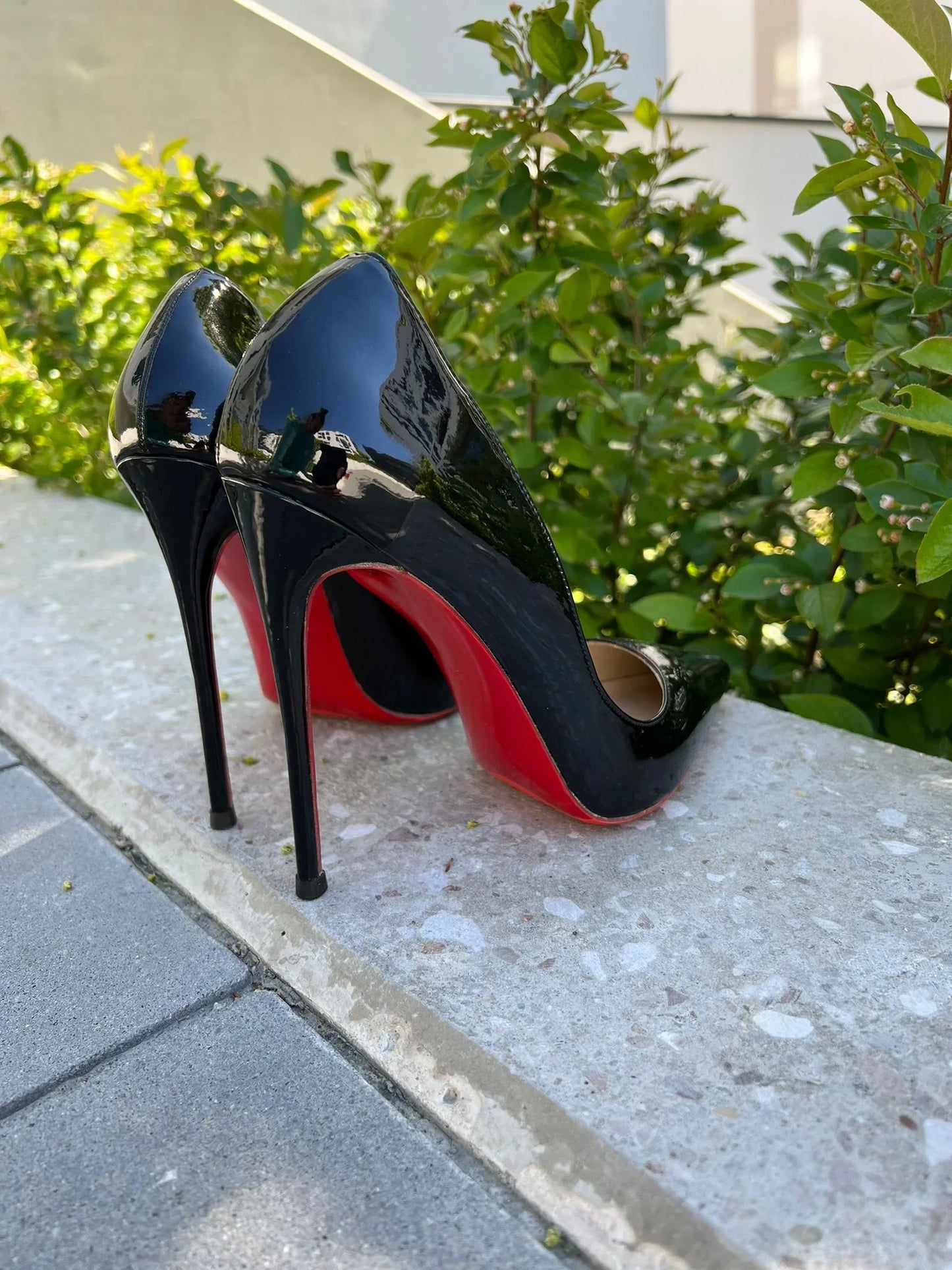 Black patent leather stiletto heels with red soles